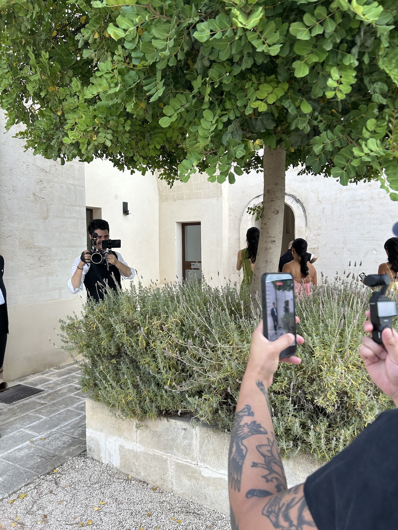 Wedding guests filming the couple on their phones