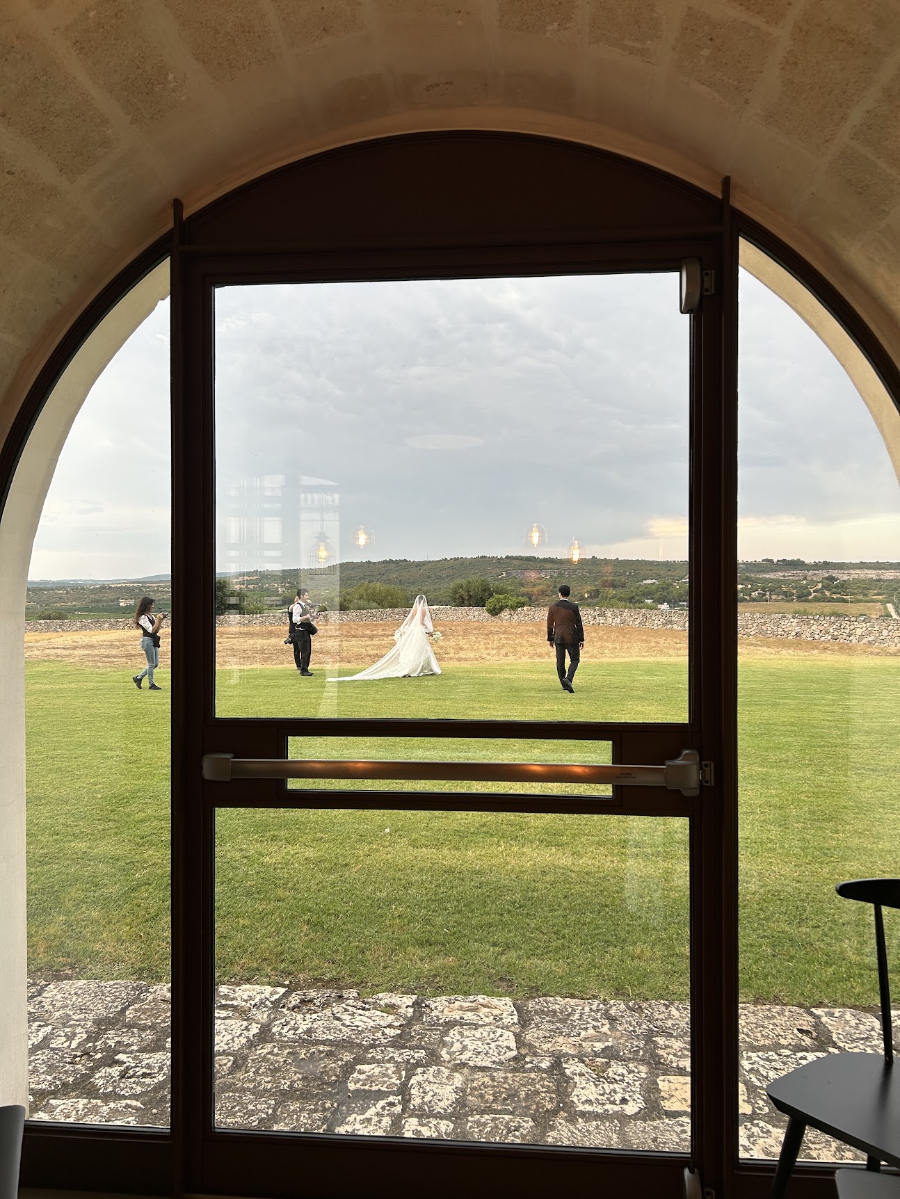 A wedding at a countryside venue, seen through an arched door